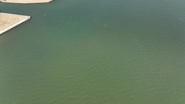 A top down drone view, directly above the Great Bay in Bay Shore, NY on a sunny day. The drone camer