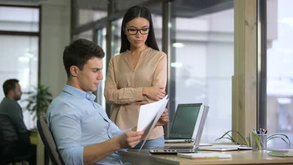 Female Boss Giving Papers With Graphs to Responsible Employee, Start-Up Company