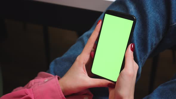 Close Up Woman Hands Holding Chromakey Green Screen Smartphone Watching Content or Video at Home