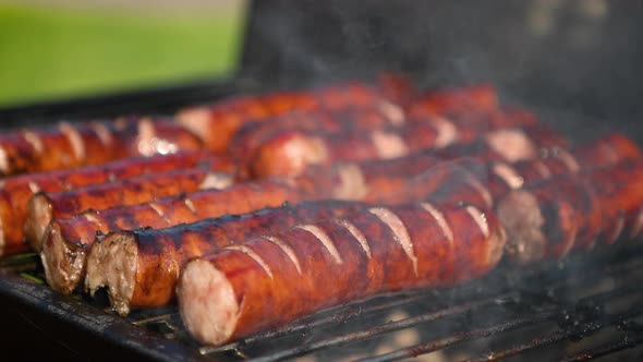 Grilling Tasty Sausages on Barbecue Grill