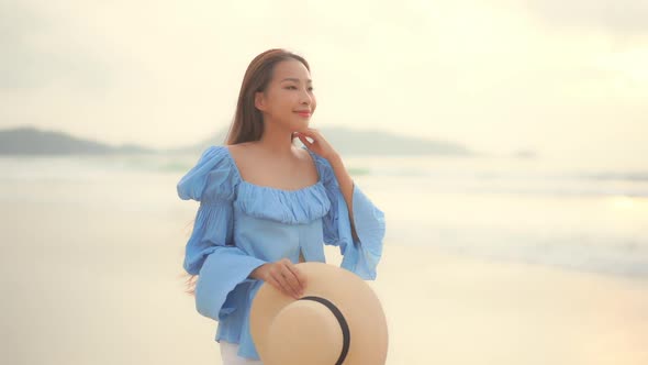 Asian woman enjoy around beautiful beach sea ocean