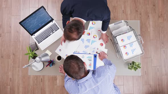 Top View of Businessman in His Office Analysing Different Charts