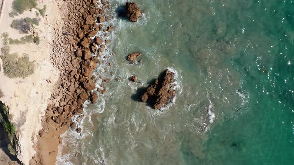 rocky coast, sea and cliffwalk in Newport beach, California. bird eyes pull back view