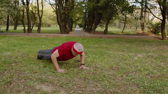 Active Senior Sportsman 80 Years Old Doing Push-ups Exercise. Workout Cardio in Park for Grandfather