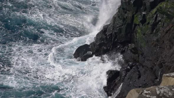 Waves Crashing Against Coastline Cliffs