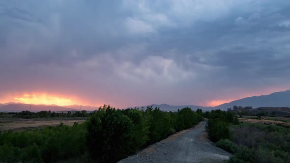 Sunset time lapse as lightning flashes through the sky