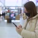 Young Woman in Shopping Mall or Trade Center Using Smartphone Mobile Phone - VideoHive Item for Sale