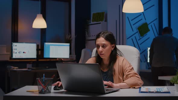 Exhausted Workaholic Businesswoman Analyzing Financial Graphics on Laptop