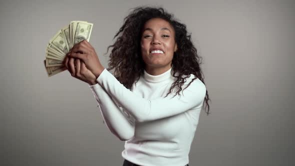 Satisfied Happy Excited African Woman Showing Money - U.S. Currency Dollars