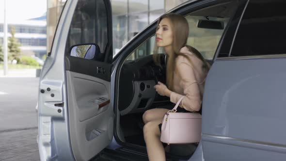 Successful Female Getting Out of the Car and Locking It, Walking to Building