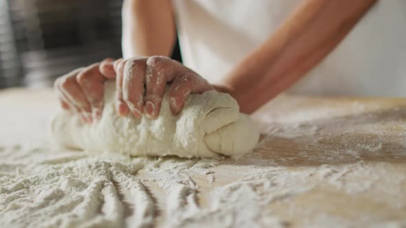Animation of hand of asian female baker preparing sourdough for bread