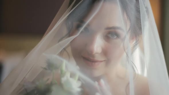 Close-up Shot of Attractive Face of Attractive Young Bride in a Veil and White Wedding Dress