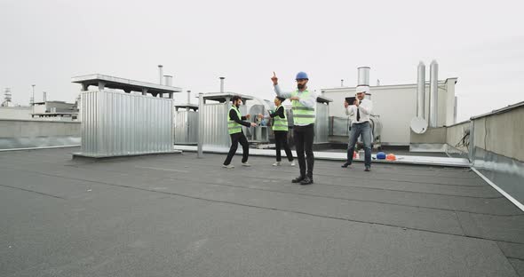 An Architecture Fine Man Dances in Front of His Worker Friends