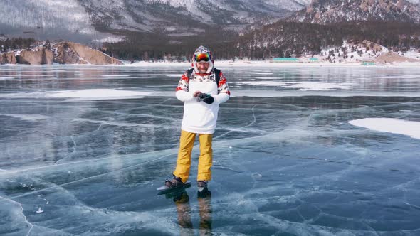 Aerial View of Man Skating on Lake Baikal Covered By Ice