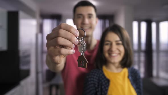 Husband and Wife Holding Keys To New Home