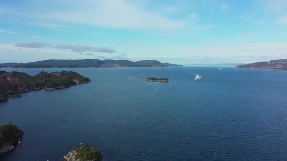 Torghatten ferry Flatoy is approaching Sandvikvaag with Bjornafjorden sea in background - Static aer