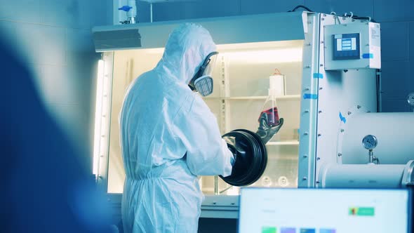 Vacuum Cabinet with a Scientist Using It to Analyze a Probe