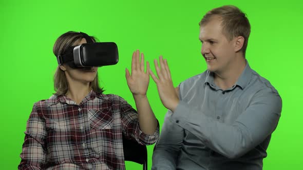 Man and Woman Using VR Headset Helmet To Play Game. Watching Virtual Reality 3D Video. Chroma Key