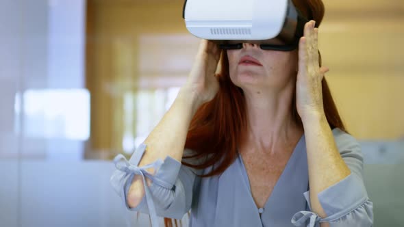 Businesswoman using virtual reality headset in a modern office 4k