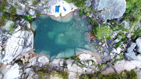 Small blue lagoon created from waterfall in Peneda Geres National Park, Portugal, Europe - drone goi
