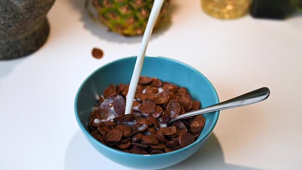 Person Pouring Up Milk In A Bowl With Cereal