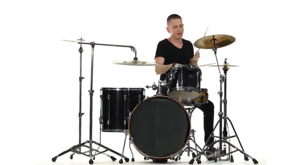 Energetic Professional Musician Plays Good Music on Drums. White Background