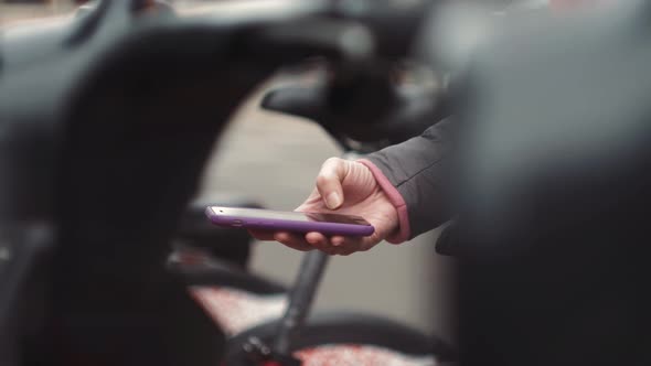 Tourist Man Take Electric Kick Scooter or Bike Bicycle in Sharing Parking Lot Tourist Phone