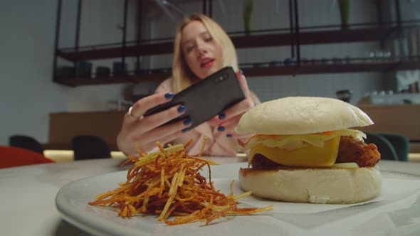 Woman Food Blogger Taking Photo of Tasty Hamburger on Phone