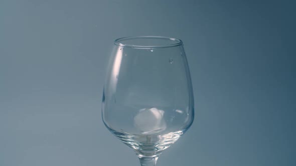 Ice Cubes Falls To the Empty Glass in Slow Motion, Adding Ice To the Drink