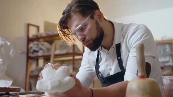 Talanted Bearded Sculptor which Using Polishing Tool to Give the Correct Shape