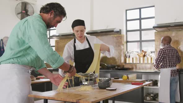 Chefs making pasta together