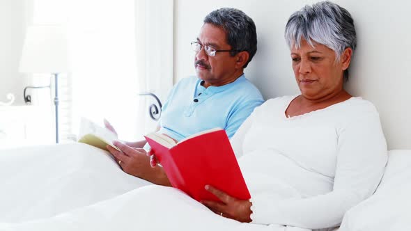 Senior couple using laptop 4 reading book 4k