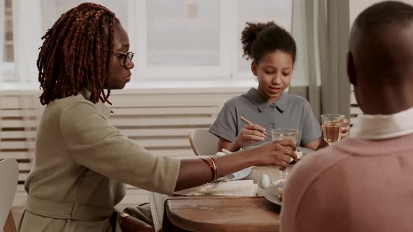 Daughter Sharing Story with Parents at Dinner