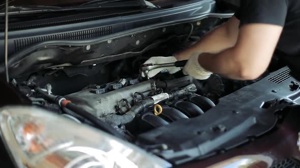 Auto Mechanic Repairing a Car Engine.