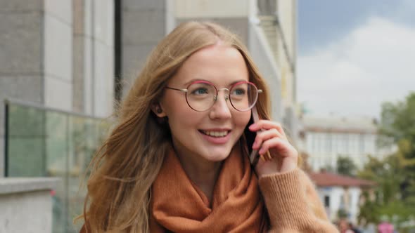 Young Girl Student Walking on Street in City Speak on Telephone Closeup Face Caucasian Woman