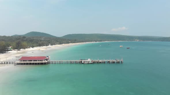 Old Wooden Pier standing above calm shallow turquoise water in Koh Rong Sanloem, Cambodia