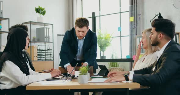 Manager which Quarrwling His Scared Confused Multiracial Subordinates About Bad Results of Work