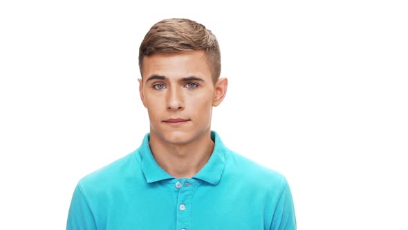 Displeased Young Man Looking at Camera Over White Background Slow Motion