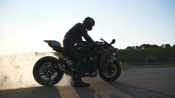 Wheel of Sport Motorbike Starting to Spin at Asphalt Road