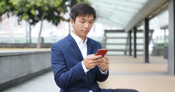 Businessman use of mobile phone at outdoor