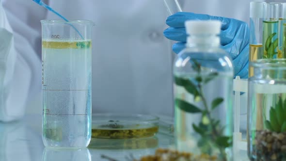 Lab Assistant Mixing Different Ingredients Making Soothing Skin-Healing Solution