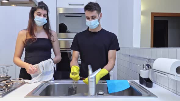 Housekeepers washing the dishes wearing protective mask Home quarantine for coronavirus COVID-19 epi