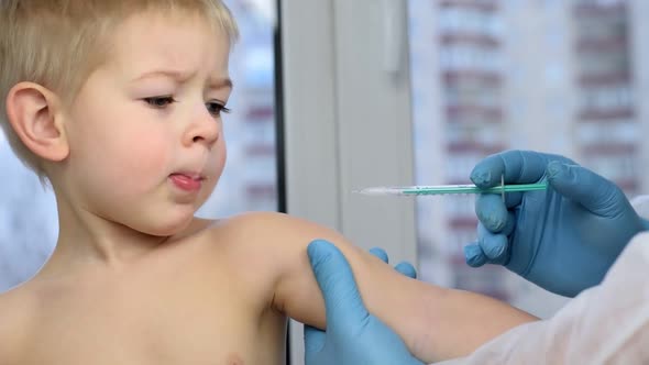 Doctor Vaccinating Cute Little Boy Closeup