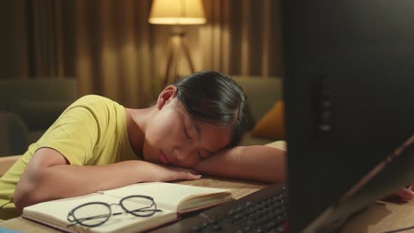 Tired Teenage Girl Sleeping On The Table While Distance Learning, Learn Online On Computer From Home