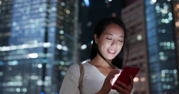 Woman work on cellphone in city