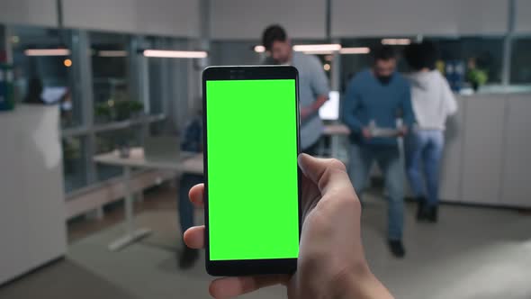 POV Shot of Entrepreneur Use Mobile Phone with Green Screen in Office