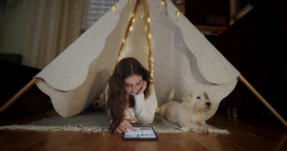 Woman Lying on the Floor with the Dog Jack Russell and Use Tablet