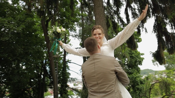 Newlyweds. Caucasian Groom with Bride Dancing in Park. Wedding Couple. Man and Woman in Love
