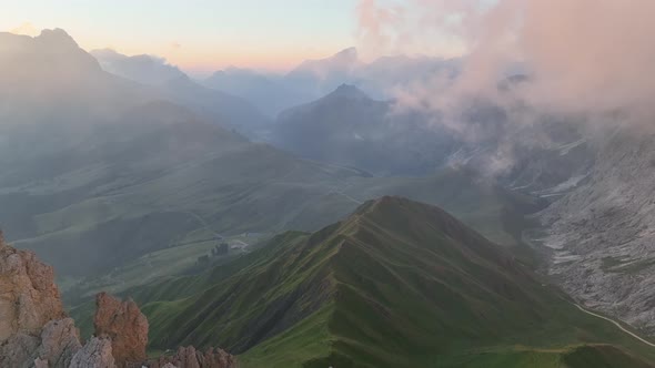 Sunrise in the Dolomites mountains with fog and mist