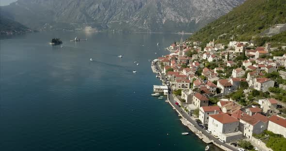 Aerial shot of Perast in on the bay of Kotor in Montenegro during a sunny day.